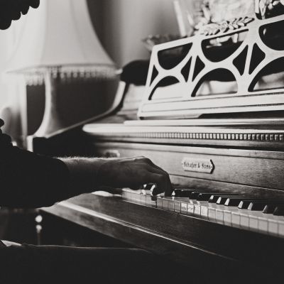Close up of man's hands playing piano